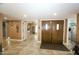 Open foyer with tiled floors and double entry doors; inviting and spacious at 25820 S Saddletree Dr, Sun Lakes, AZ 85248