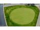 Aerial close-up of a well-maintained green on the golf course at 25820 S Saddletree Dr, Sun Lakes, AZ 85248