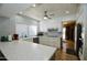 Bright kitchen featuring white cabinets, modern appliances, light countertops and recessed lighting at 25820 S Saddletree Dr, Sun Lakes, AZ 85248