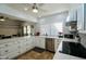 Bright kitchen featuring stainless steel appliances and white cabinets at 25820 S Saddletree Dr, Sun Lakes, AZ 85248