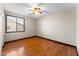 Cozy bedroom boasts wood flooring, a ceiling fan, and natural light at 2925 E Cathy E Dr, Gilbert, AZ 85296