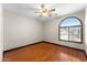 A bedroom with hardwood floors and an arched window letting in natural light at 2925 E Cathy E Dr, Gilbert, AZ 85296