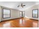 Spacious bedroom features hardwood floors, neutral walls, ceiling fan, and bright windows at 2925 E Cathy E Dr, Gilbert, AZ 85296