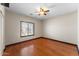 This bedroom features hardwood floors, a ceiling fan and a window letting in natural light at 2925 E Cathy E Dr, Gilbert, AZ 85296