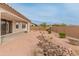 Low maintenance backyard with desert landscaping, rock features, and covered patio, perfect for outdoor enjoyment at 3287 N 197Th Ln, Buckeye, AZ 85396