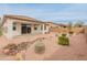 Backyard featuring a covered patio, desert landscaping, a rock stream bed and a privacy wall at 3287 N 197Th Ln, Buckeye, AZ 85396