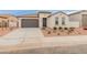 Charming single-story home featuring a neutral color scheme, two-car garage and low maintenance landscaping at 3287 N 197Th Ln, Buckeye, AZ 85396