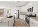 Modern kitchen featuring stainless steel appliances, white cabinetry, and granite countertops at 3287 N 197Th Ln, Buckeye, AZ 85396