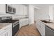 Modern kitchen featuring stainless steel appliances, white cabinetry, and granite countertops at 3287 N 197Th Ln, Buckeye, AZ 85396