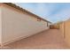 A side yard featuring desert landscaping, including small gravel and view of fencing at 3287 N 197Th Ln, Buckeye, AZ 85396