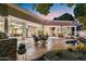 Expansive back patio featuring outdoor dining area, pool and hot tub, outdoor kitchen and stunning architecture at 3441 S Camellia Pl, Chandler, AZ 85248