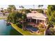 Aerial view of a beautiful backyard featuring a pool, spa, fire pit, lush landscaping, and tranquil waterfront at 3441 S Camellia Pl, Chandler, AZ 85248