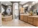 Bathroom features a soaking tub, double vanity, and decorative wallpaper at 3441 S Camellia Pl, Chandler, AZ 85248