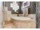 Soaking tub with tile surround and decoratively tiled backsplash at 3441 S Camellia Pl, Chandler, AZ 85248