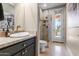 Bathroom with stylish vanity and a glass shower leading to the backyard at 3441 S Camellia Pl, Chandler, AZ 85248