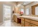 Bathroom with double sinks, vanity, and an open view of the soaking tub at 3441 S Camellia Pl, Chandler, AZ 85248