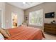 Bedroom with an ensuite bathroom and plantation shutters at 3441 S Camellia Pl, Chandler, AZ 85248