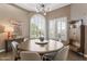 Chic dining room with a round table, stylish chandelier, and beautiful window shutters at 3441 S Camellia Pl, Chandler, AZ 85248