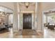 Spacious foyer with travertine floors, designer lighting, and views into adjacent living spaces at 3441 S Camellia Pl, Chandler, AZ 85248