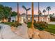 Elegant home with circular entryway, palm trees, and manicured landscaping at 3441 S Camellia Pl, Chandler, AZ 85248