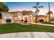 Elegant home exterior featuring a circular entryway, lush lawn, and desert landscaping at 3441 S Camellia Pl, Chandler, AZ 85248