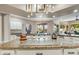 This open kitchen features granite counters, a central island, and modern stainless appliances at 3441 S Camellia Pl, Chandler, AZ 85248