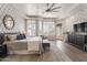 Spacious main bedroom features tray ceilings, brick accent wall, plush carpet, and plantation shutters at 3441 S Camellia Pl, Chandler, AZ 85248