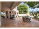 Expansive covered patio offers an outdoor dining area with views of the well-maintained backyard at 3441 S Camellia Pl, Chandler, AZ 85248