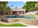 Inviting pool with waterfall feature and lush landscaping creates a backyard oasis at 3441 S Camellia Pl, Chandler, AZ 85248