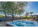 Backyard featuring a hot tub, patio with seating, mature trees, and privacy wall at 3531 E Onyx Ave, Phoenix, AZ 85028