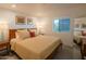 Bedroom with a comfortable queen-size bed, natural light, and stylish bedside decor at 3531 E Onyx Ave, Phoenix, AZ 85028