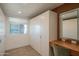 A closet with white storage cabinets and adjacent vanity area illuminated by a light-up mirror at 3531 E Onyx Ave, Phoenix, AZ 85028