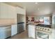 Bright kitchen with stainless refrigerator, gas range and view into open dining and living space at 3531 E Onyx Ave, Phoenix, AZ 85028