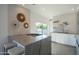 Open-concept kitchen with marble island, gas cooktop, and stainless sink near a sliding glass door at 3531 E Onyx Ave, Phoenix, AZ 85028