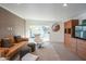 Stylish living room with exposed brick accent wall, sleek furniture, and sliding door to outdoor area at 3531 E Onyx Ave, Phoenix, AZ 85028