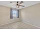 Bright, well-lit bedroom with tile floor, window, and neutral walls at 3646 N 69Th Ave # 38, Phoenix, AZ 85033