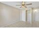 Bright bedroom with tile floors, ceiling fan, closet and neutral-colored walls at 3646 N 69Th Ave # 38, Phoenix, AZ 85033