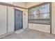 Protected front door with decorative metal security screen and concrete pad entry at 3646 N 69Th Ave # 38, Phoenix, AZ 85033