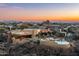 Expansive aerial view of a luxury home at sunset with a private pool and mountain views at 40947 N 107Th Pl, Scottsdale, AZ 85262