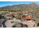 Aerial view of a desert home with a circular drive and beautiful mountain views at 40947 N 107Th Pl, Scottsdale, AZ 85262