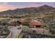 Stunning aerial view of a desert home with a red tile roof and mountain backdrop at 40947 N 107Th Pl, Scottsdale, AZ 85262