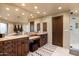 A primary bathroom showcasing a dual vanity with granite counters and a wooden-framed mirror at 40947 N 107Th Pl, Scottsdale, AZ 85262