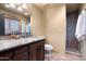 Chic bathroom with a granite vanity, wood cabinetry, and walk-in shower at 40947 N 107Th Pl, Scottsdale, AZ 85262