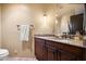 Bathroom featuring a granite vanity, wood cabinetry, and granite tile floors at 40947 N 107Th Pl, Scottsdale, AZ 85262