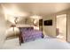 Serene bedroom showcasing neutral tones, ambient lighting, and an en-suite bathroom at 40947 N 107Th Pl, Scottsdale, AZ 85262