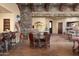 Dining area with stone accents and a view of the bar area and entry way at 40947 N 107Th Pl, Scottsdale, AZ 85262