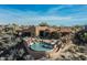 Desert home features a private pool, hot tub, lounging area, and desert landscaping at 40947 N 107Th Pl, Scottsdale, AZ 85262