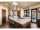 Spacious kitchen boasts granite island, stainless oven, wood cabinets, and stylish pendant lighting at 40947 N 107Th Pl, Scottsdale, AZ 85262