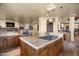 Bright kitchen featuring center island with cooktop, granite counters and wood cabinetry at 40947 N 107Th Pl, Scottsdale, AZ 85262