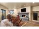 Living area featuring a stone fireplace, comfortable seating, and stylish decor at 40947 N 107Th Pl, Scottsdale, AZ 85262